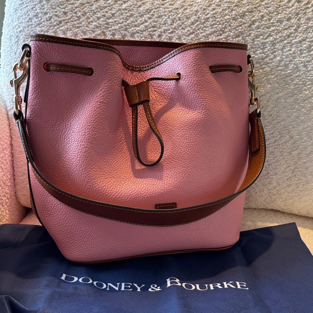 Dooney & Bourke pebbled leather shoulder bucket style bag in the color salmon